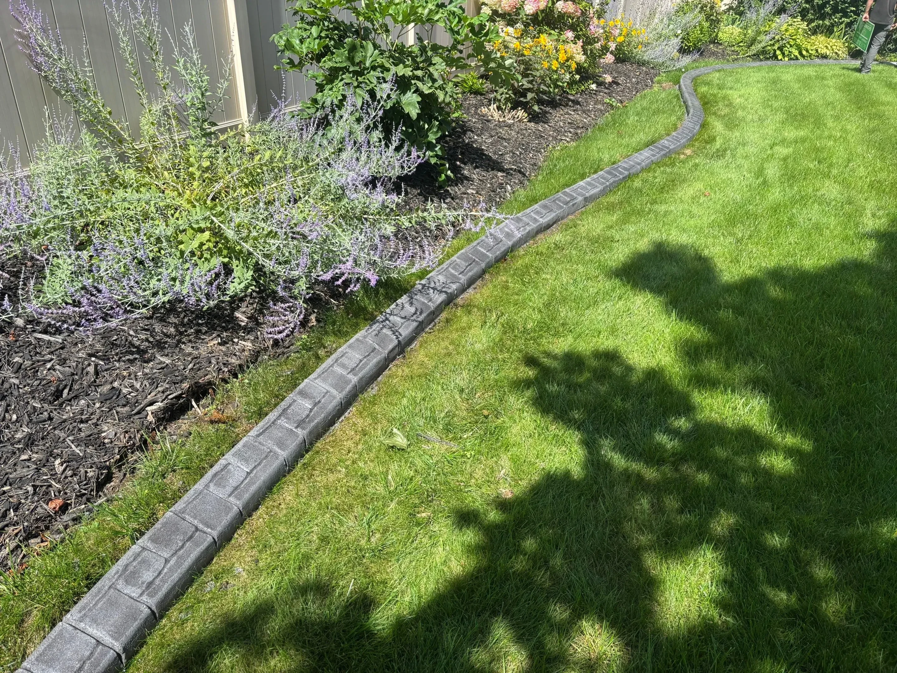 Professional landscape curbing tools and equipment on a Minnesota residential property Professional landscape curbing tools and equipment on a Minnesota residential property